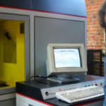SLA manager, Dave Caron, operates the computer controls of the stereolithography machine.