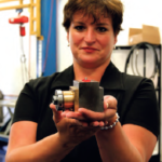 Lisa Bailey-Beavers, national sales manager of GTI Spindle, inspects a Heald grinder dressing spindle.