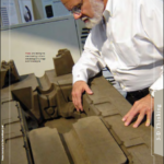 Larry looking into a sand-casting mold and core package of a vintage automotive engine
