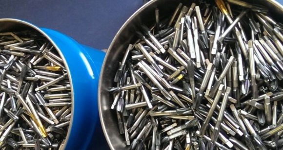 Show Me the Tungsten Scrap carbide cutting tools in blue bins for recycing